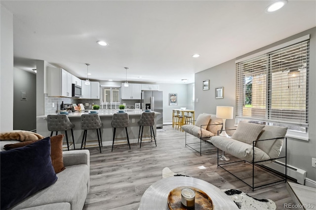 1390 Everett Ct Unit 105, Lakewood, CO 80215 - living room with recessed lighting, light wood-type flooring, and baseboards