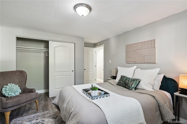 1390 Everett Ct Unit 105, Lakewood, CO 80215 - bedroom featuring wood finished floors, a closet, and baseboards