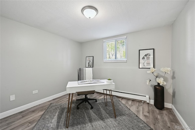 1390 Everett Ct Unit 105, Lakewood, CO 80215 - home office with a baseboard radiator, wood finished floors, baseboards, and a textured ceiling