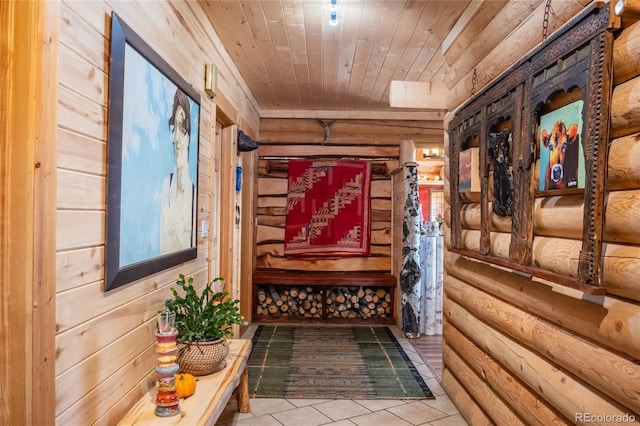 hallway featuring log walls, light tile patterned floors, and wooden ceiling