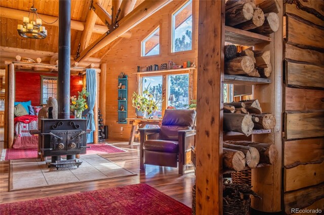 361 Crystal Peak Rd, Florissant, CO 80816 - living room with wood ceiling, beam ceiling, a wood stove, high vaulted ceiling, and hardwood / wood-style floors