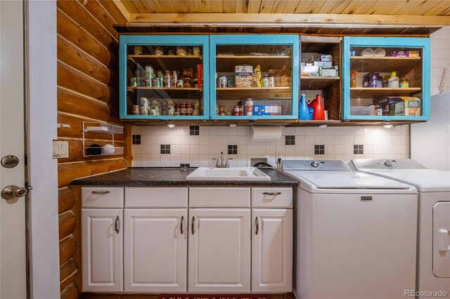 361 Crystal Peak Rd, Florissant, CO 80816 - washroom with cabinets, wooden ceiling, independent washer and dryer, sink, and wooden walls