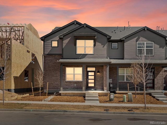 764 N Tempe St, Aurora, CO 80018 - view of front of house featuring a shingled roof and brick siding