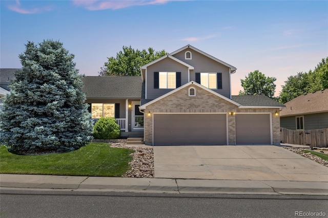 20858 E Progress Ave, Centennial, CO 80015 - view of front facade with an attached garage, concrete driveway, brick siding, covered porch, and roof with shingles
