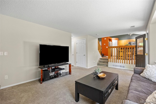 20858 E Progress Ave, Centennial, CO 80015 - carpeted living room featuring a textured ceiling and stairs