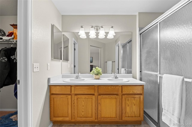 20858 E Progress Ave, Centennial, CO 80015 - full bathroom featuring double vanity, a spacious closet, a shower stall, and a chandelier