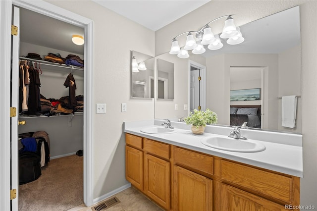 20858 E Progress Ave, Centennial, CO 80015 - full bath featuring double vanity, a spacious closet, and a chandelier