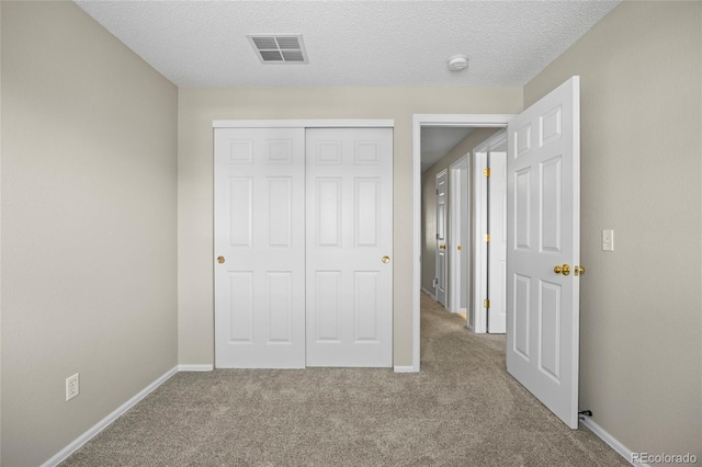 20858 E Progress Ave, Centennial, CO 80015 - unfurnished bedroom featuring carpet floors, a closet, and a textured ceiling
