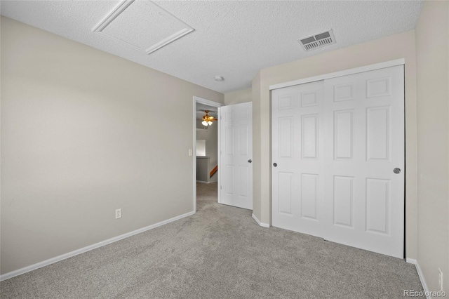 20858 E Progress Ave, Centennial, CO 80015 - unfurnished bedroom with carpet, a closet, a textured ceiling, and attic access
