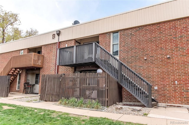 view of property with fence and stairway