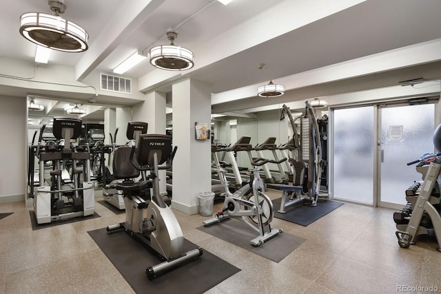 exercise room with visible vents and baseboards