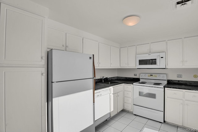 kitchen featuring white cabinetry, white appliances, sink, and light tile patterned floors