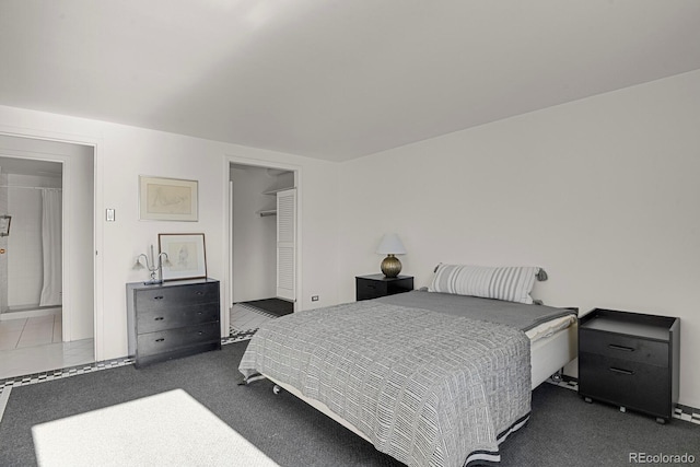 bedroom with a closet and dark carpet