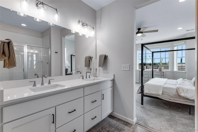 944 Alpine Ridge St, Erie, CO 80516 - bathroom with ensuite bathroom, double vanity, ceiling fan, baseboards, and wood finished floors