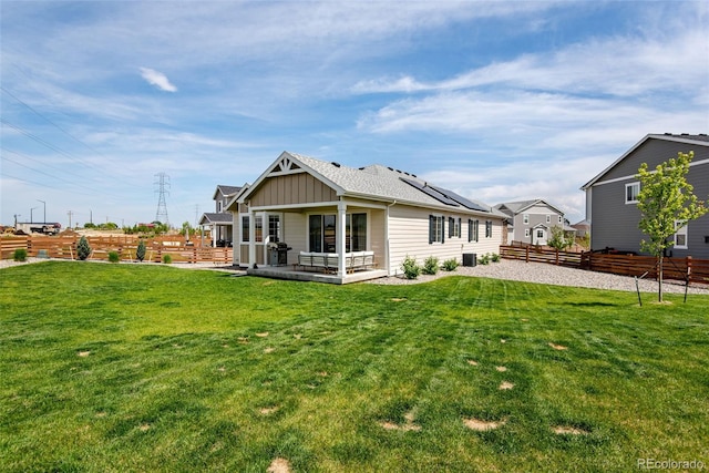 944 Alpine Ridge St, Erie, CO 80516 - back of property featuring board and batten siding, roof mounted solar panels, and central AC unit