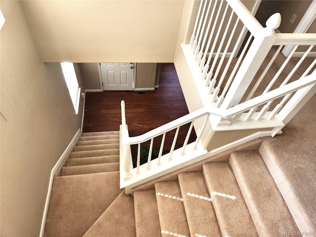 stairway featuring wood-type flooring