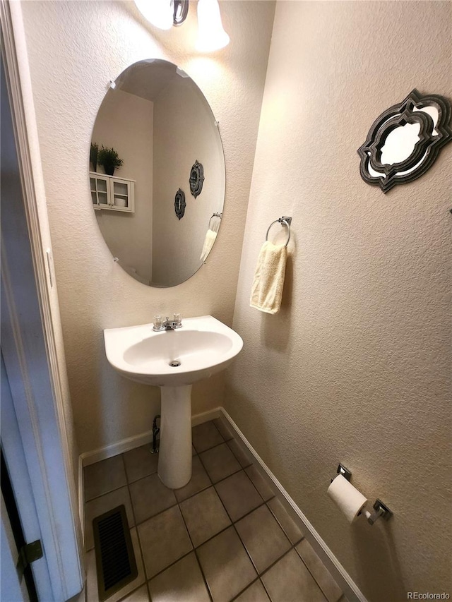 bathroom with tile patterned floors