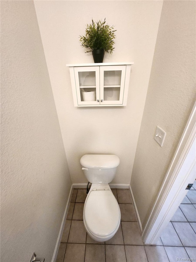 bathroom with tile patterned flooring and toilet