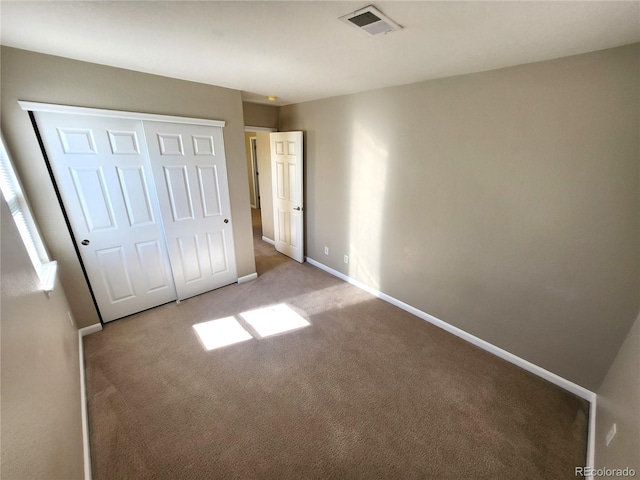 unfurnished bedroom with carpet and a closet