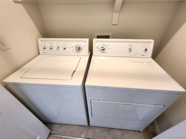 laundry room with separate washer and dryer and tile patterned floors