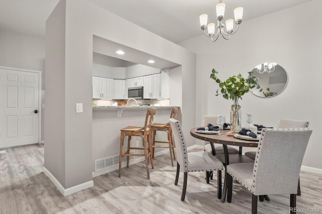 6868 Los Reyes Cir, Colorado Springs, CO 80918 - dining room with light wood-style flooring, baseboards, a chandelier, and recessed lighting