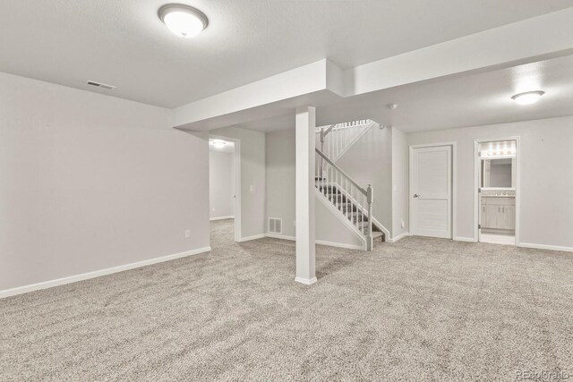 6868 Los Reyes Cir, Colorado Springs, CO 80918 - finished below grade area featuring carpet floors, stairway, and baseboards