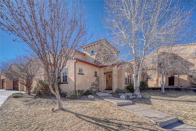 mediterranean / spanish house with a tiled roof, driveway, and stucco siding