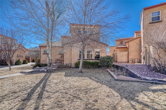 view of front of property with a tiled roof and stucco siding