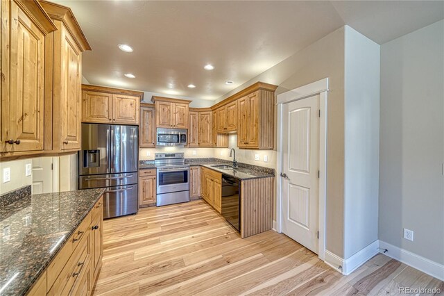 304 Cottonwood Cir Unit A, Salida, CO 81201 - kitchen with appliances with stainless steel finishes, a sink, light wood-style flooring, dark stone counters, and recessed lighting