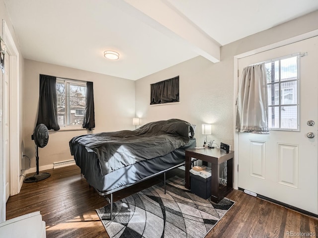 bedroom with dark hardwood / wood-style floors, beam ceiling, and baseboard heating