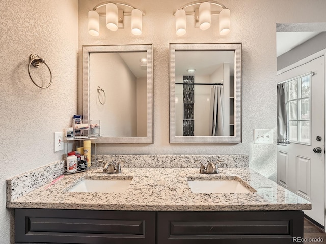 bathroom with walk in shower and vanity