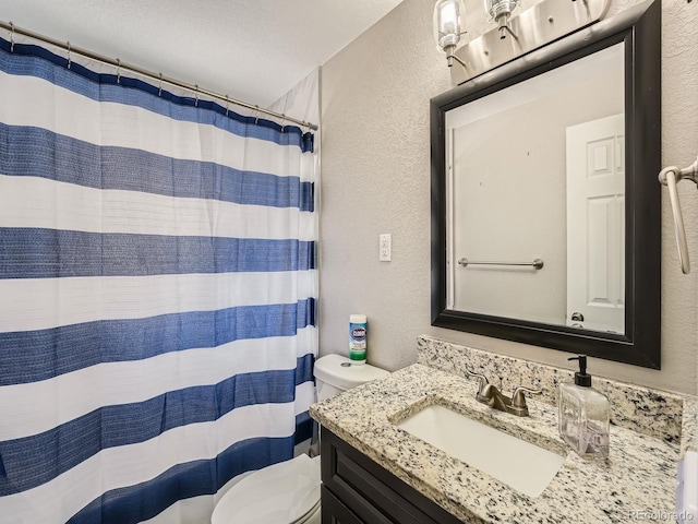 bathroom featuring walk in shower, vanity, a textured ceiling, and toilet