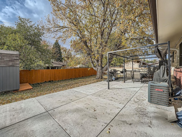 view of patio with cooling unit and area for grilling