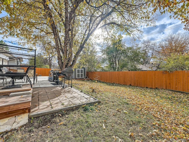 view of yard with a storage shed and a wooden deck