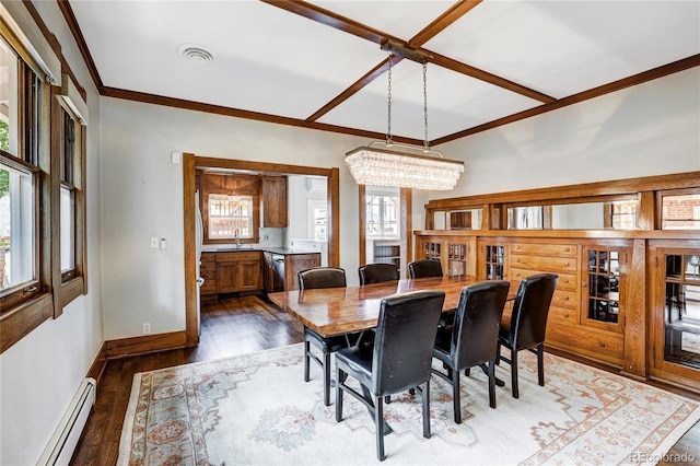 dining area with wood-type flooring, plenty of natural light, baseboard heating, and a chandelier