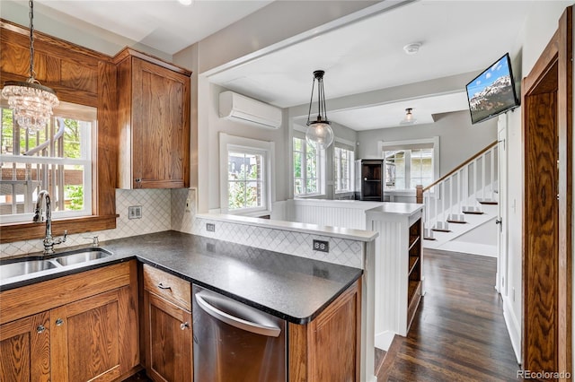 kitchen with a wealth of natural light, an AC wall unit, dark wood-type flooring, and backsplash