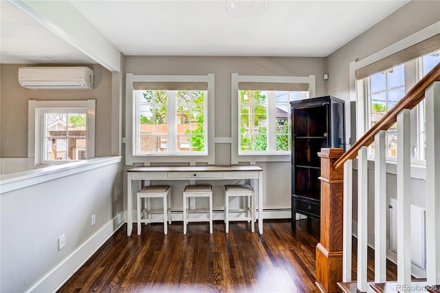 interior space with dark hardwood / wood-style flooring and a wall mounted air conditioner