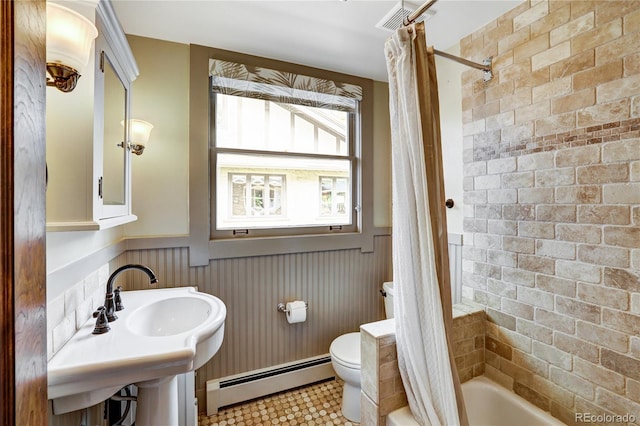 bathroom with shower / tub combo, a baseboard radiator, toilet, and tile floors