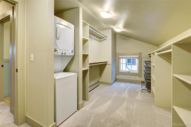 spacious closet featuring stacked washer / dryer, light carpet, and a baseboard radiator