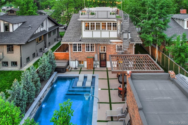 exterior space featuring a patio, a balcony, and a fenced in pool