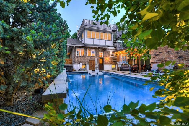 view of swimming pool featuring a patio area