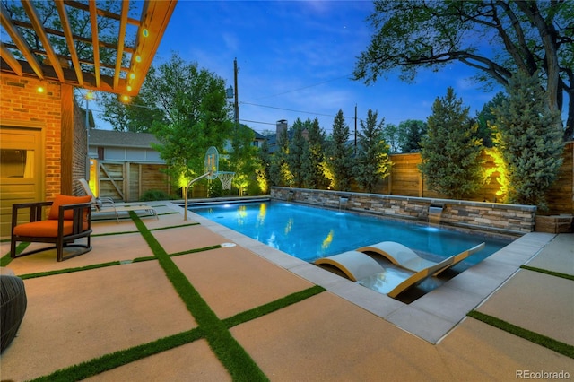 view of pool featuring pool water feature, a patio, and a pergola