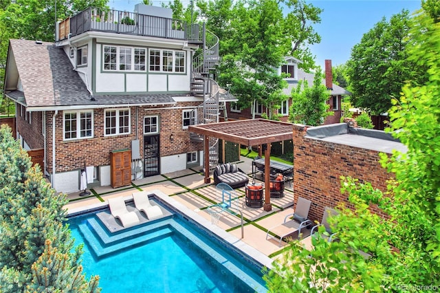 rear view of house with a balcony and a patio area