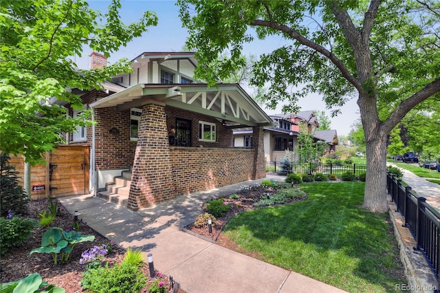 tudor-style house featuring a front yard