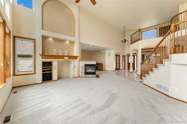 6323 S Sicily Way, Aurora, CO 80016 - unfurnished living room with carpet flooring, stairs, a high ceiling, baseboards, and a fireplace