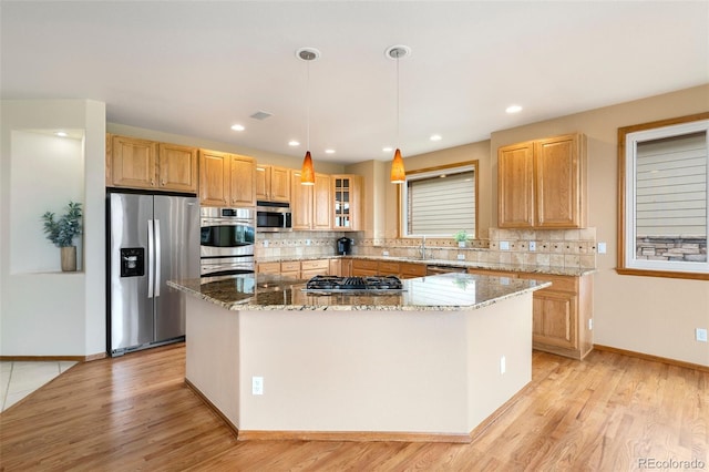 6323 S Sicily Way, Aurora, CO 80016 - kitchen with stainless steel appliances, a kitchen island, light wood-style flooring, and recessed lighting