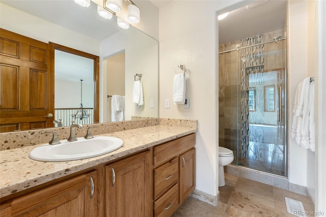 6323 S Sicily Way, Aurora, CO 80016 - full bath featuring vanity, toilet, a shower stall, stone finish floors, and baseboards