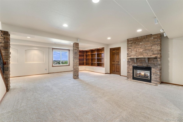 6323 S Sicily Way, Aurora, CO 80016 - unfurnished living room featuring a stone fireplace, carpet flooring, baseboards, and recessed lighting