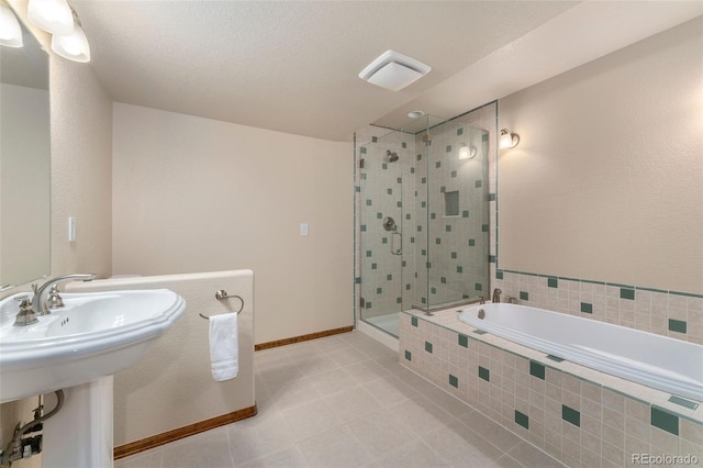 6323 S Sicily Way, Aurora, CO 80016 - bathroom with a shower stall, a garden tub, tile patterned floors, a sink, and baseboards