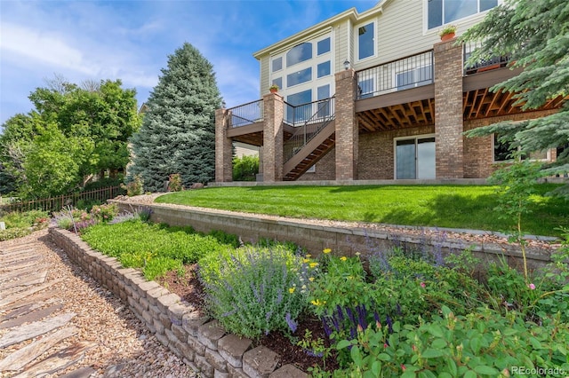6323 S Sicily Way, Aurora, CO 80016 - back of house with a wooden deck, stairs, a lawn, and brick siding
